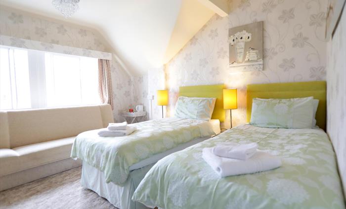 This Twin room offers flexibility as it easily transforms into a Superking. 
Enjoy its bright ambiance and relax in the comfortable seating area.